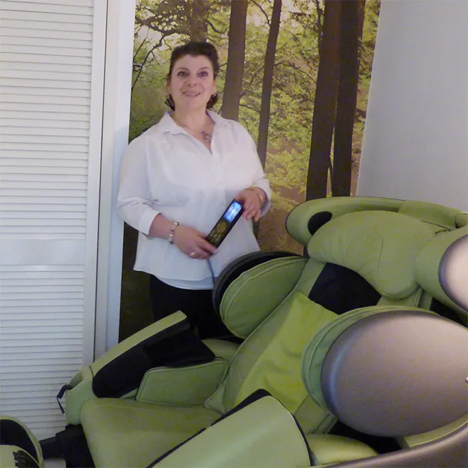 The green 3D massage chair in the relaxation suite