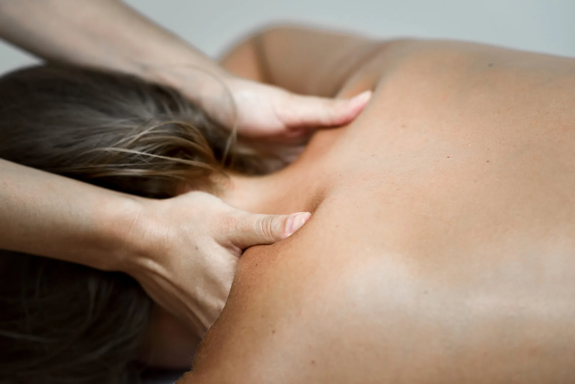 Woman relaxing face down during a back massage treatment