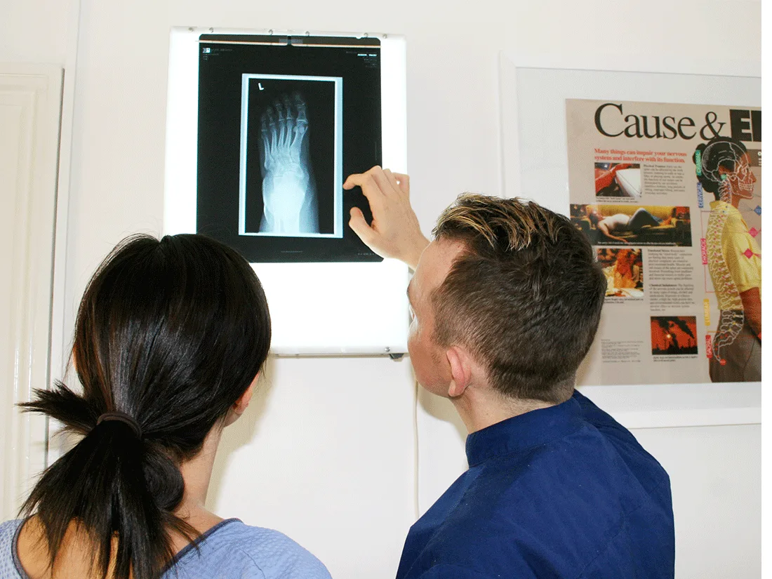 Chiropractor reviewing an x-ray with a patient